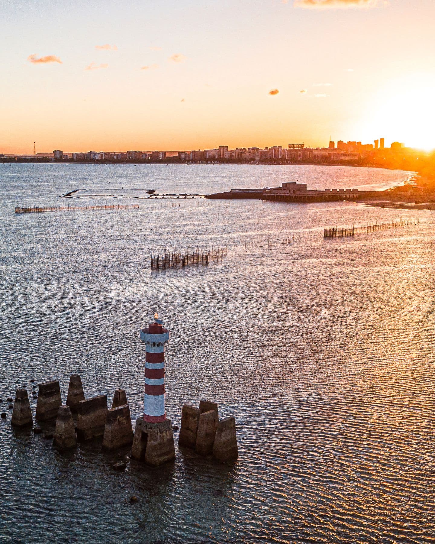 Farol da Ponta Verde no fim da tarde, com a orla de Maceió iluminada pelo sol baixo